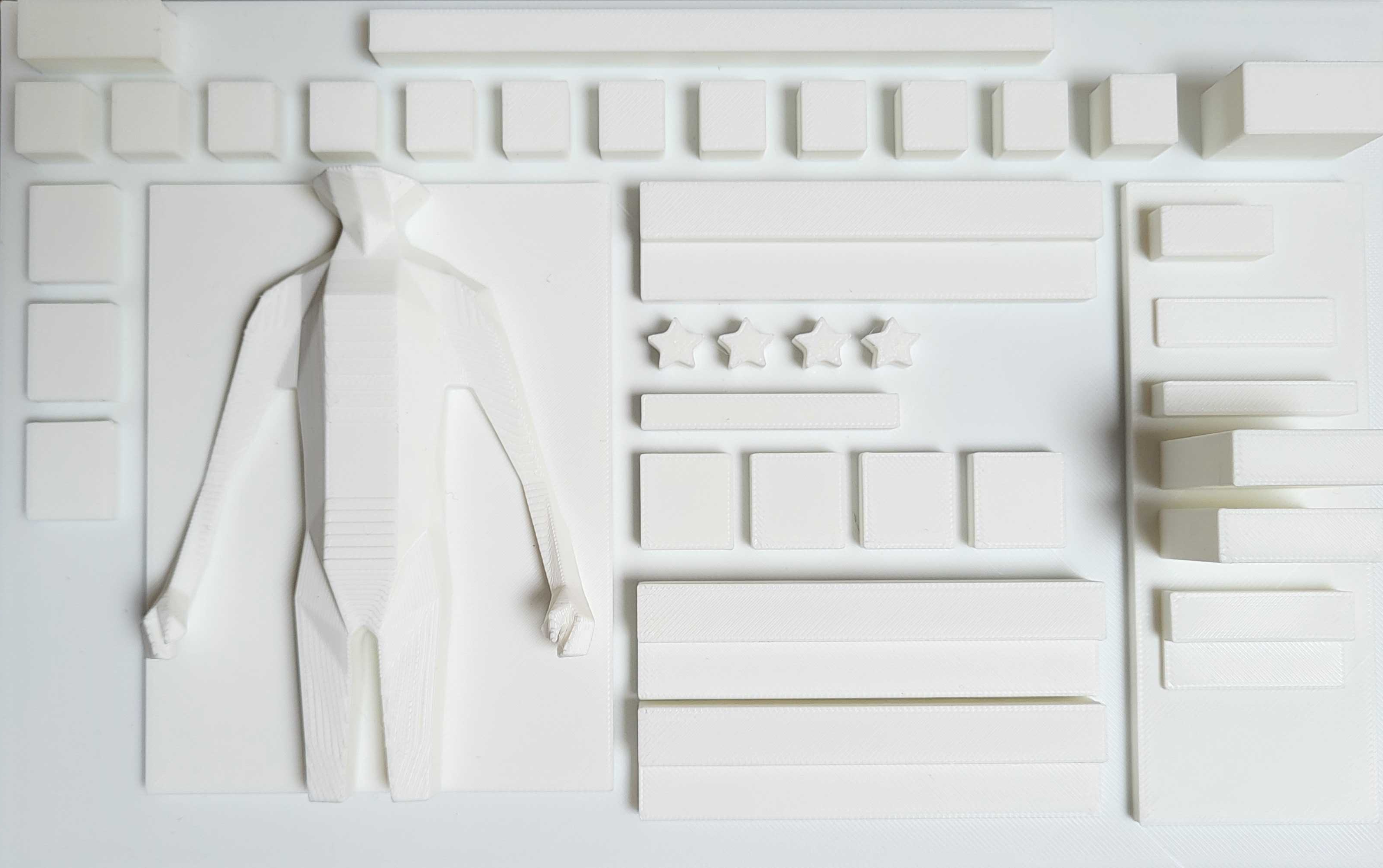 White 3D printed tactile model representing a digital interface layout with raised controls and shapes.